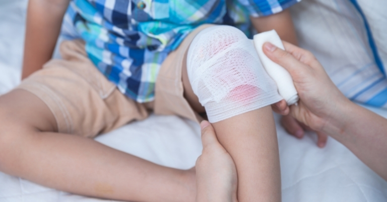 Image of a child with a bandaged kneee