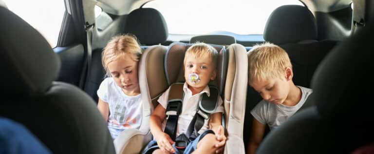 Children in the backseat of car.
