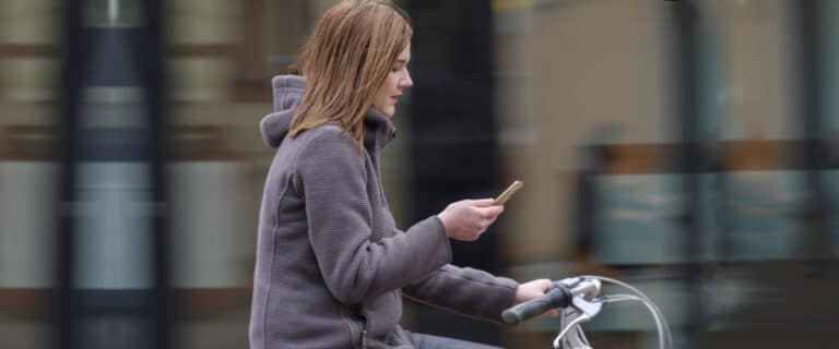 image of girl texting while biking